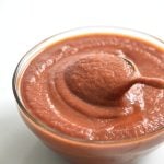 bowl of sugar free BBQ sauce i a clear bowl with a spoon
