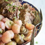 instant pot pot roast with radishes on a white background