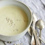 Instant pot cream of broccoli stalk soup in a white bowl with spoons