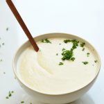 keto cauliflower soup on a white background with parsley